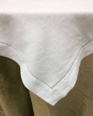 traditional white hemstitch overlay over burlap linen
